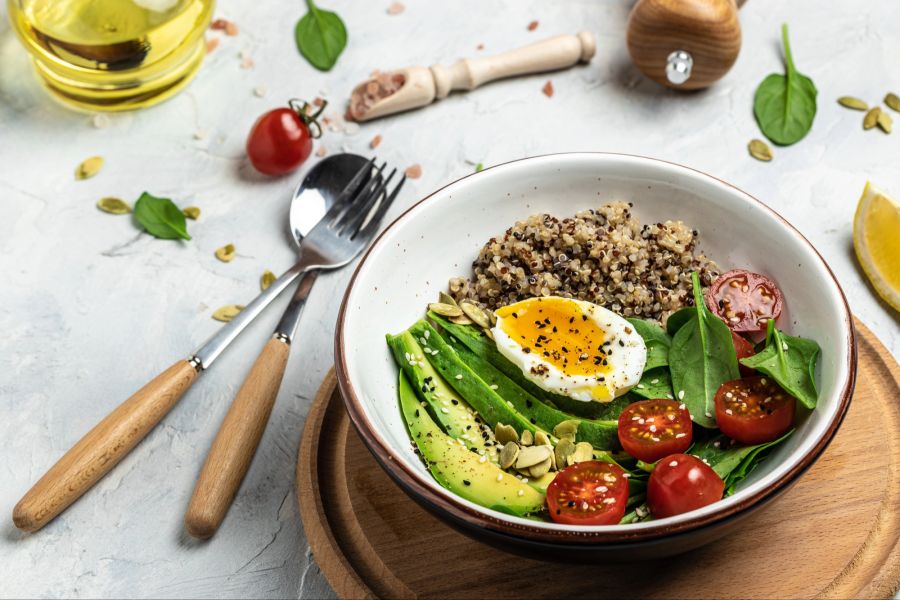 Teller mit Ei, Avocado, Tomaten und Quinoa