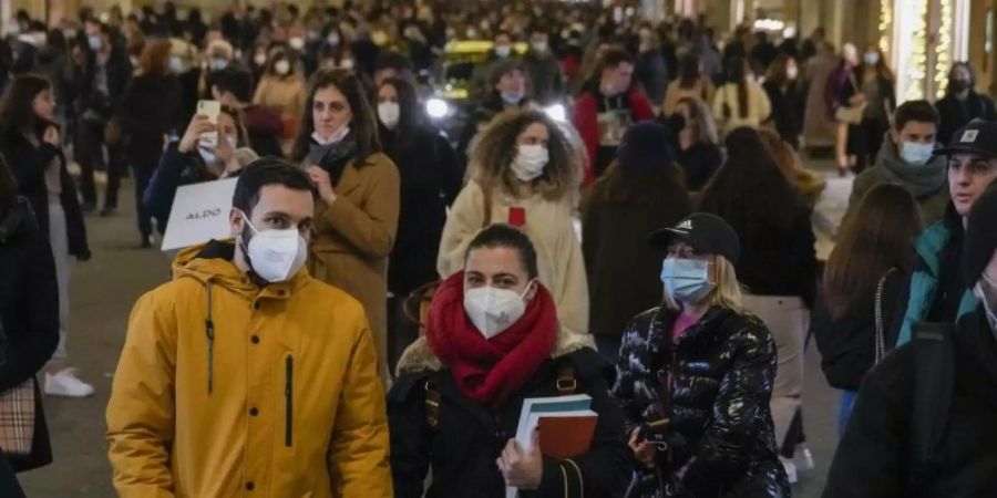 Menschen auf einer Einkaufsstrasse in Rom. Foto: Andrew Medichini/AP/dpa