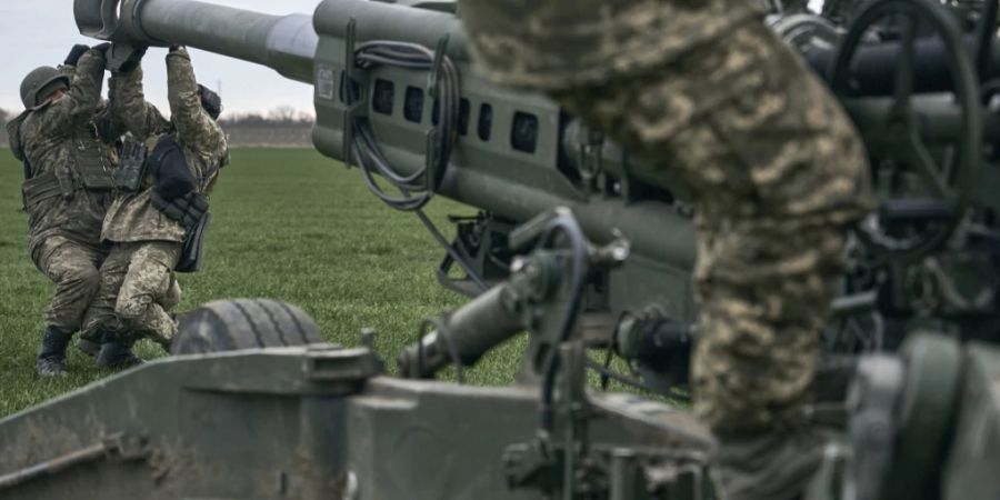 ARCHIV - Ukrainische Soldaten bereiten in Cherson eine von den USA gelieferte M777 Haubitze für den Beschuss einer feindlichen Stellung vor. Foto: Libkos/AP/dpa