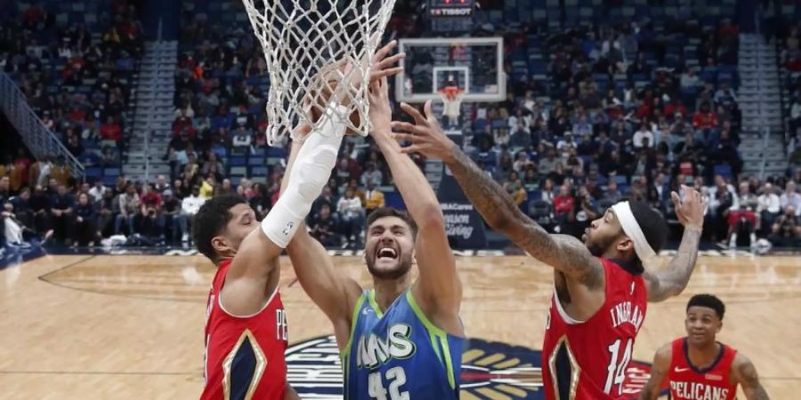 Der deutsche Mavericks-Profi Maxi Kleber (M.) setzt sich am Korb gleich gegen zwei Gegenspieler durch. Foto: Gerald Herbert/AP/dpa