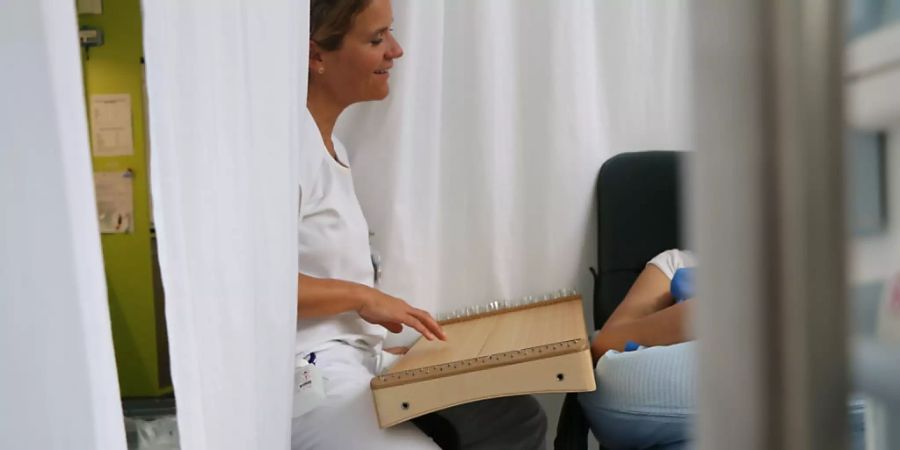 Dr. rer. medic. Friederike Haslbeck, Klinik für Neonatologie Zürich, bei der Musiktherapie mit dem Monochord. Die Auswirkungen der Kreativen Musiktherapie auf die Hirnentwicklung von Frühchen konnten definitiv nachgewiesen und aufgezeichnet werden. (Pressebild)