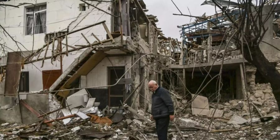 Mann vor den Trümmern eines Hauses in Stepanakert