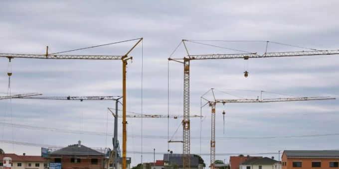 Baukräne in einem Neubaugebiet Baukräne in einem Neubaugebiet
