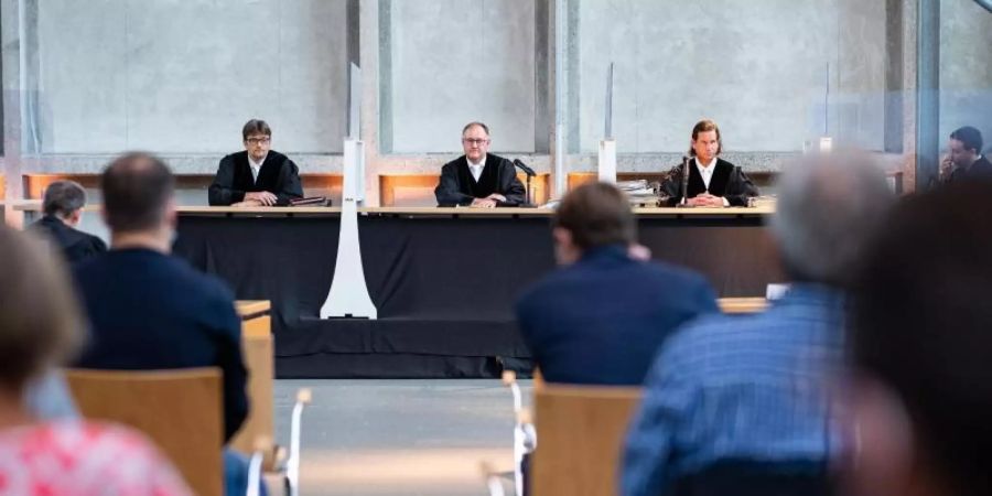 Der Vorsitzende Richter Johannes Wieseler (M) und seine Kollegen Volker Messing (l) und Dirk Pelzer sitzen zu Beginn der Berufungsverhandlung zu den Schadensersatzforderungen der Hinterbliebenen des Germanwings-Absturzes 2015 in der Lobby des Oberlandesgerichtes. Foto: Guido Kirchner/dpa