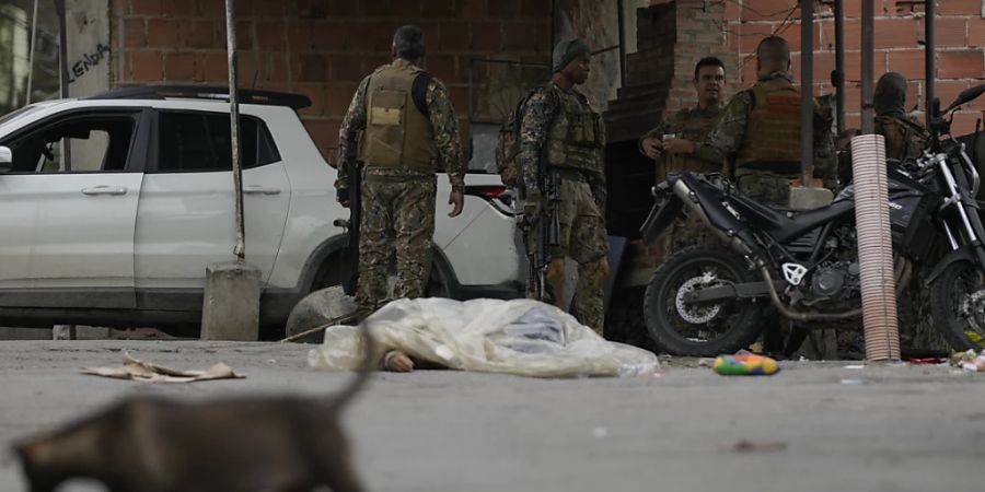 Der bedeckte Körper eines Mannes liegt auf der Strasse, nachdem er bei einem Polizeieinsatz gegen mutmassliche Drogenhändler in der Favela Vila Cruzeiro in Rio de Janeiro getötet wurde. Nach Angaben der Militärpolizei des Bundesstaates starben bei dem Einsatz mindestens acht Menschen. Foto: Silvia Izquierdo/AP/dpa