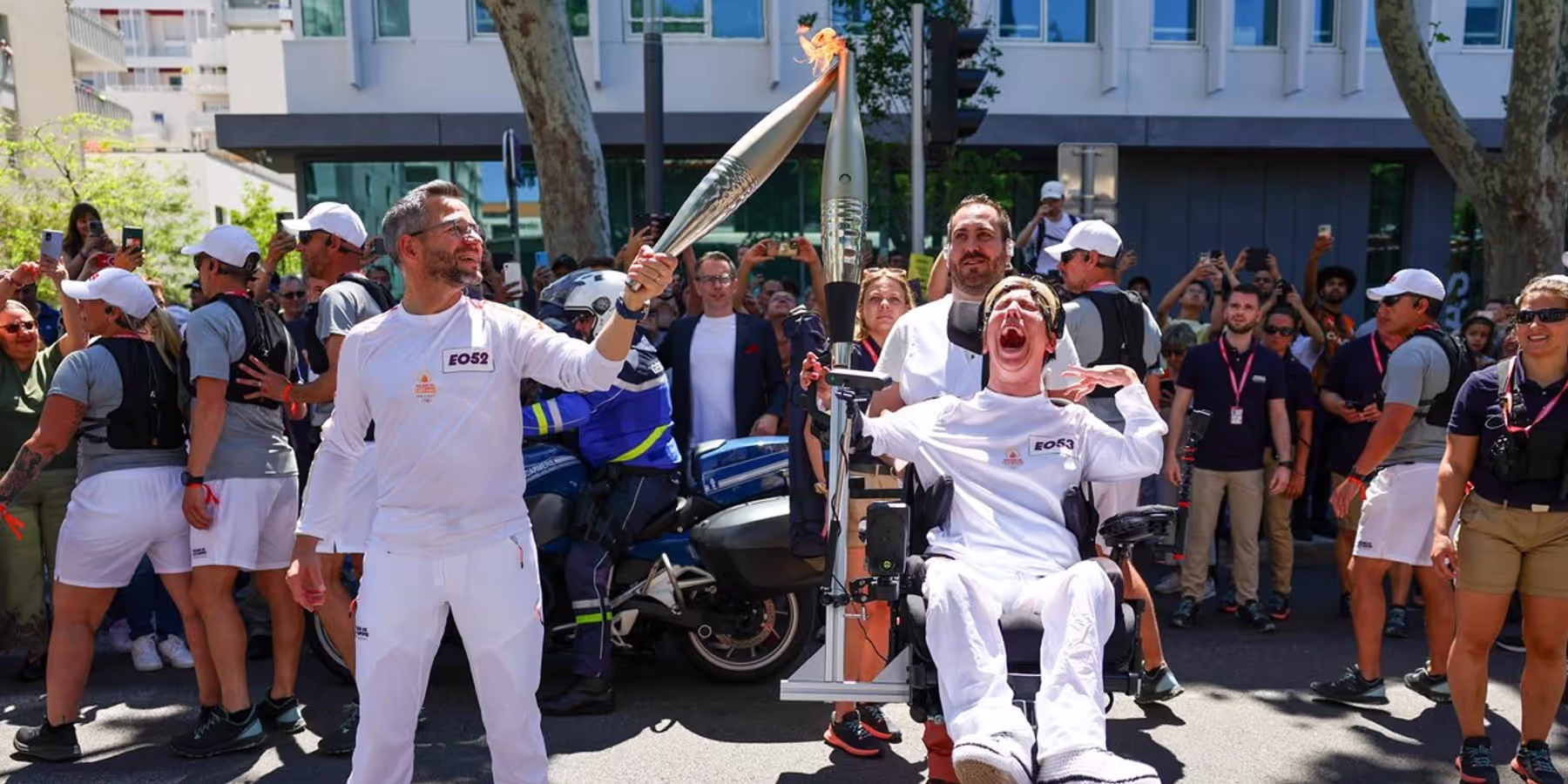 Nathalie carrying the Olympic flame with the exoskeleton arm