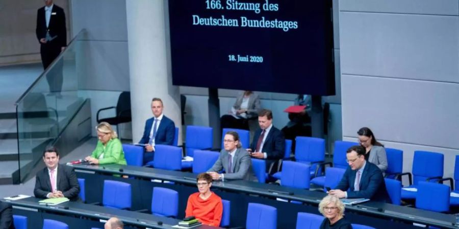 Bundeskanzlerin Angela Merkel (vorne r.) und weitere Mitglieder der Bundesregierung sitzen auf der Regierungsbank im Bundestag. Foto: Kay Nietfeld/dpa