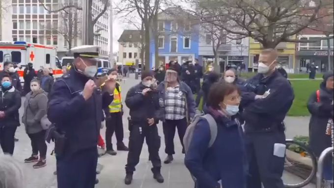 Eine Frau will dem Vortrag über das Coronavirus des Polizeichefs nicht mehr zuhören. Sie wendet sich von ihm ab. Coronavirus