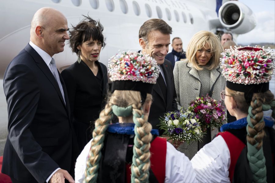 Zu Ehren des Heimatkantons von Alain Berset begrüssen auch Mädchen in Sensler Kränzlitrachten Emmanuel und Brigitte Macron.