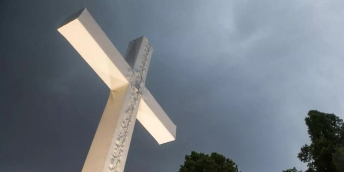 Dunkle Wolken über einem Kreuz. Foto: picture alliance / Lino Mirgeler/dpa Dunkle Wolken über einem Kreuz. Foto: picture alliance / Lino Mirgeler/dpa