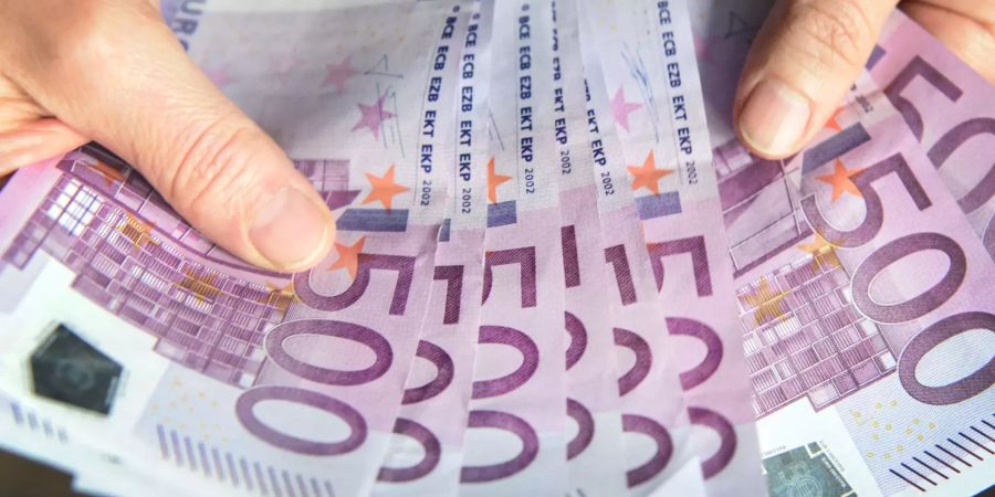 Eine Frau zählt 500-Euro-Geldscheine.