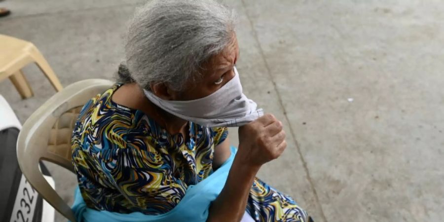 Indische Frau beim Warten auf eine Anti-Corona-Impfung