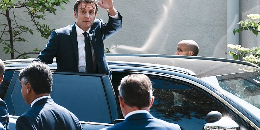 Emmanuel Macron, Präsident von Frankreich, winkt aus seinem Auto, nachdem er seine Stimme abgegeben hat. Foto: Thibault Camus/AP/dpa