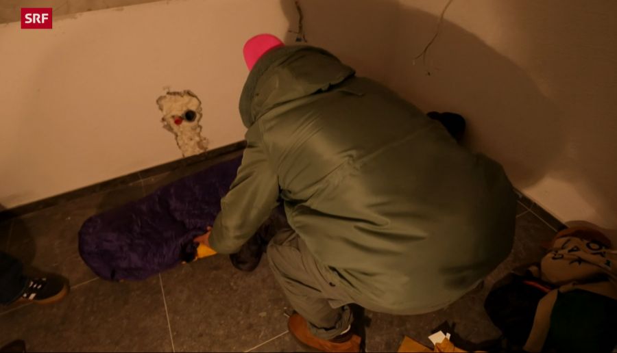Jan Fitze richtet sich seinen Schlafplatz auf dem Boden im leeren Zimmer ein.