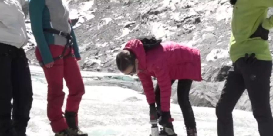 Mit dem Eisbohrer entnehmen die Schülerinnen einen Eisbohrkern aus dem Gletscher. An Eisbohrkernen und den eingeschlossenen Gasbläschen können Forschende die Klimavergangenheit rekonstruieren.