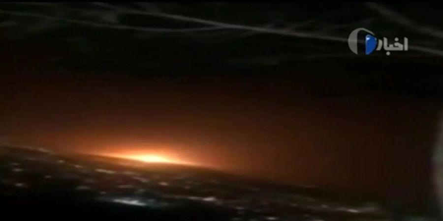An image grab from footage obtained from Iranian State TV IRIB on June 26, 2020, shows an orange light resulting from what the defence ministry said was a gas tank explosion that rocked Tehran overnight