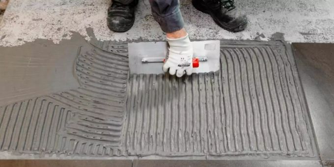 Ein Arbeiter belegt einen Boden. Foto: Markus Scholz/dpa-tmn/dpa/Symbolbild Boden