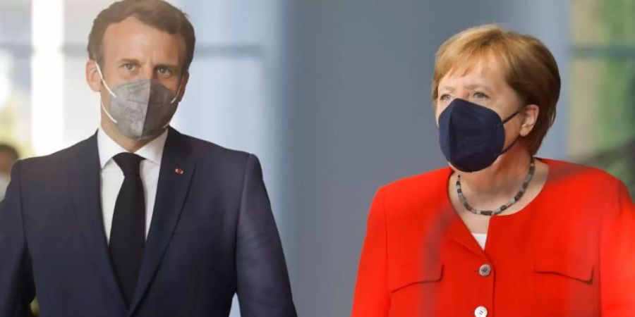 Bundeskanzlerin Angela Merkel und Frankreichs Präsident Emmanuel Macron zusammen in Berlin. Foto: Axel Schmidt/Reuters-Pool/dpa