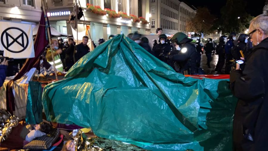 Die Polizei räumt auch die Zelte und Planen weg.