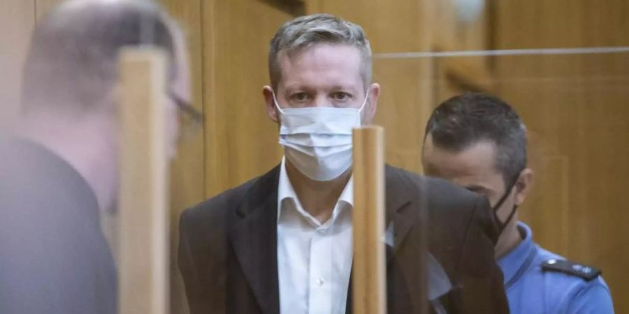 Der Hauptangeklagte Stephan Ernst (M) soll den nordhessischen Regierungspräsidenten Lübcke vor einem Jahr auf dessen Terrasse erschossen haben, weil sich der CDU-Politiker für Flüchtlinge eingesetzt hatte. Foto: Boris Roessler/dpa-Pool/dpa