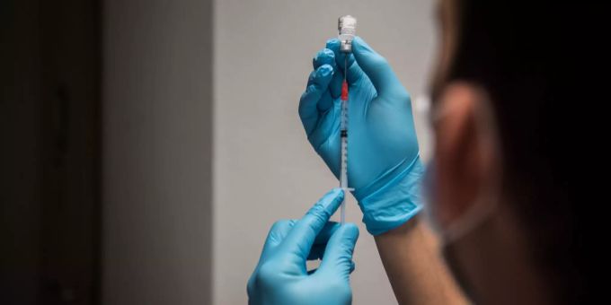 Ein Pfleger füllt eine Spritze mit dem Corona-Impfstoff der Hersteller Pfizer/Biontech. coronavirus impfung