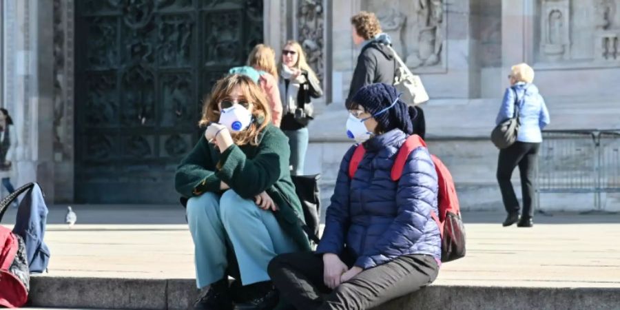 Menschen mit Atemschutzmasken in Mailand