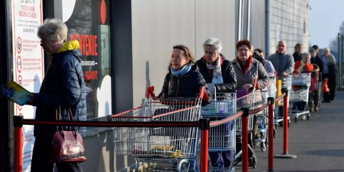 Schlange vor belgischem Supermarkt. Coronavirus