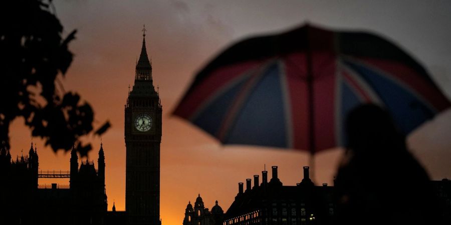 Eine Frau steht bei Sonnenuntergang am Big Ben Schlange, um Königin Elizabeth II. die letzte Ehre zu erweisen.