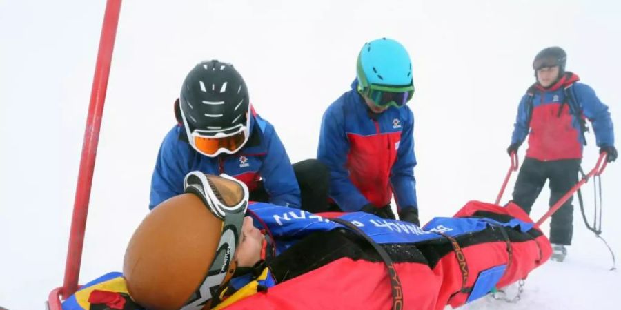 Teilnehmer eines Lehrganges für Bergretter der Bergwacht trainieren auf dem Nebelhorn bei Oberstdorf (Bayern) den Umgang mit einem Ackja. Foto: picture alliance / Karl-Josef Hildenbrand/dpa