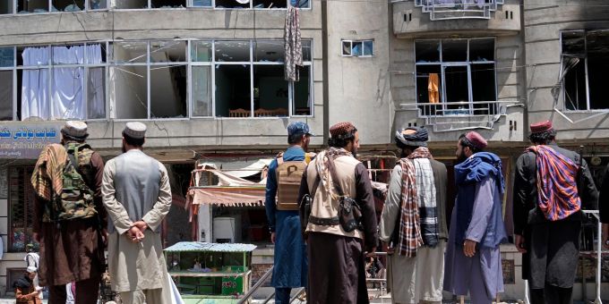 Taliban-Kämpfer versammeln sich am Ort einer Explosion vor einem Sikh-Tempel. Taliban