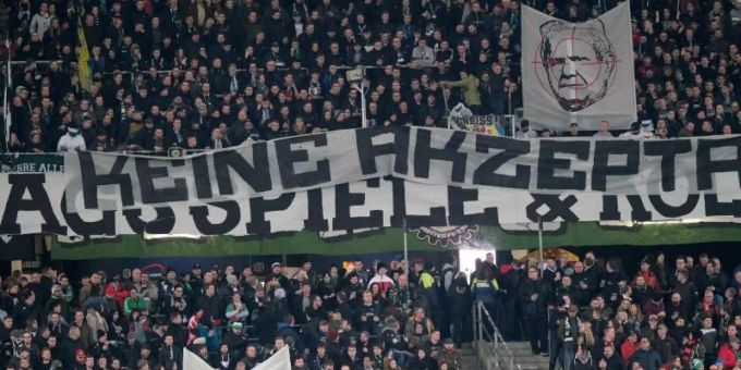 Fans von Hannover 96 zeigen provokante Banner mit Hoffenheim-Boss Dietmar Hopp im Fadenkreuz. Foto: Peter Steffen/dpa Dietmar Hopp