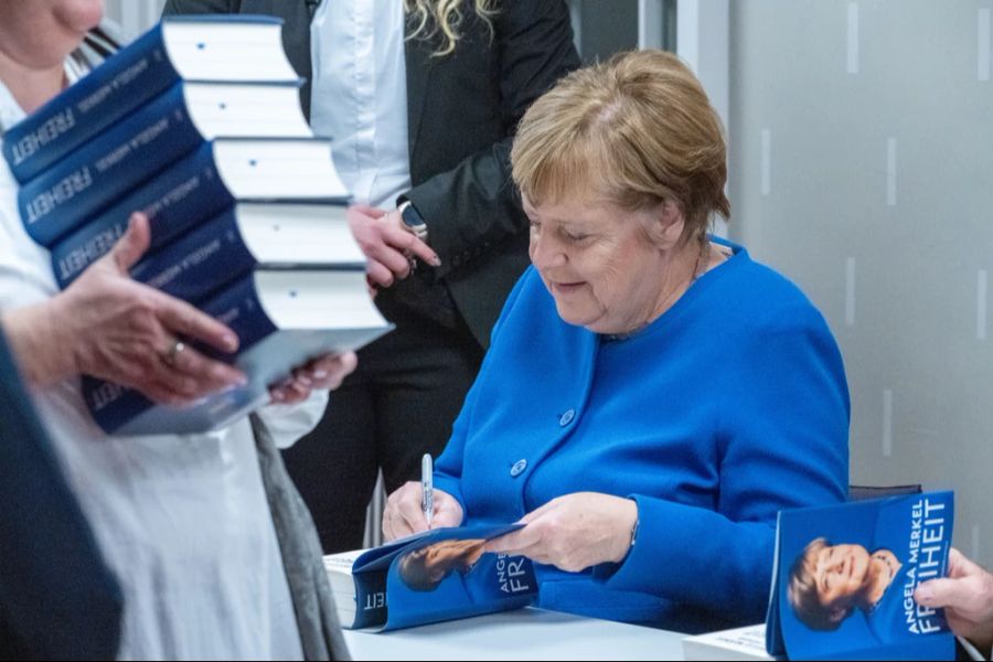 Angela Merkel signiert Buch