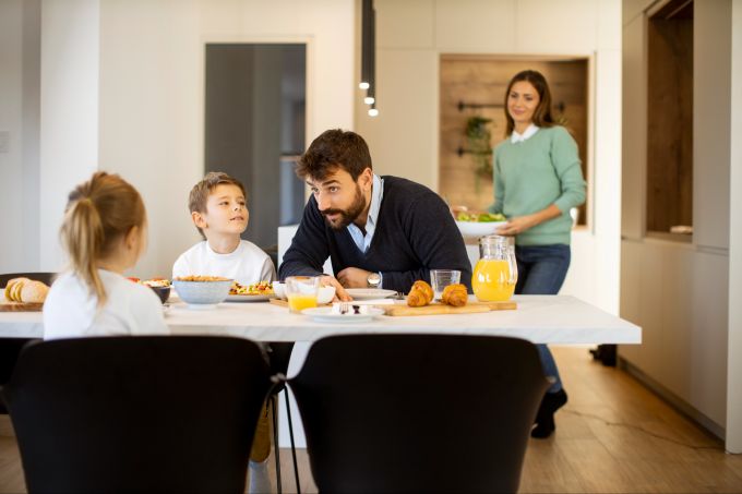 Ob gemeinsame Essenszeiten oder festgelegte Hausaufgabenzeiten ‒ Struktur und Rituale sind wichtig für Kinder. Familie am Frühstückstisch