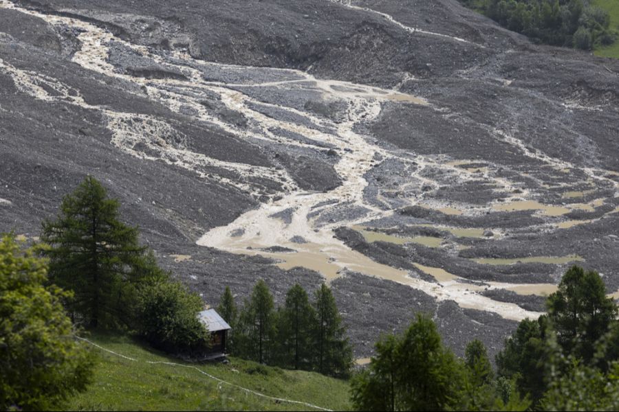 Die Lonza überflutet nach der See­bildung Schlamm und Geröll bei den letzten Häusern von Blatten.