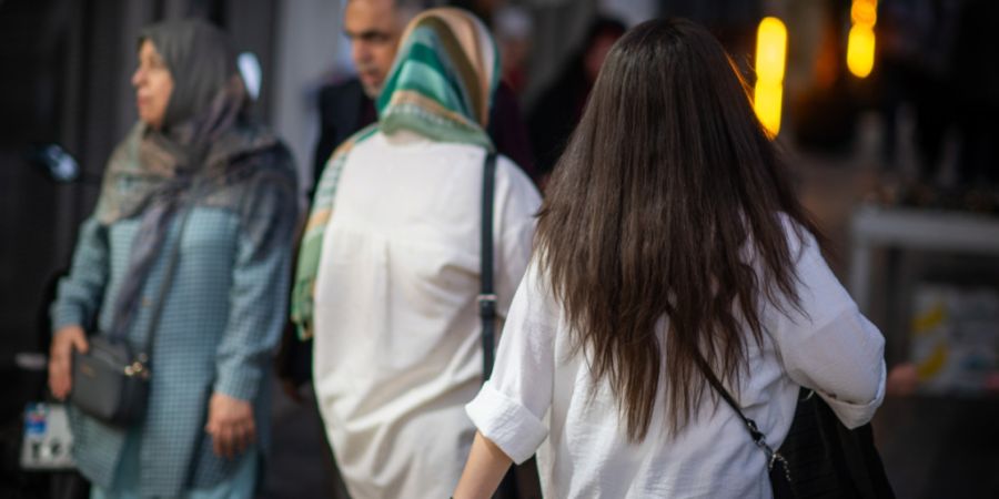 ARCHIV - Eine Frau läuft in Teheran mit offenen Haaren am Abend eine Straße entlang. Foto: Arne Immanuel Bänsch/dpa