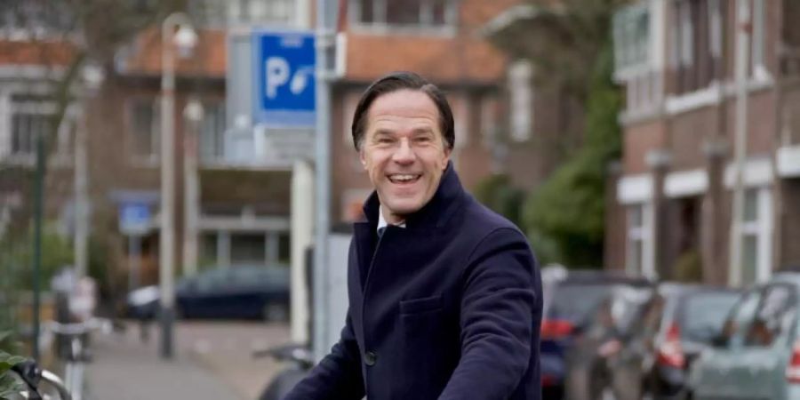Grund zur Freude: Mark Rutte kommt mit einem Fahrrad in einem Wahllokal in Den Haag an. Foto: Sylvia Lederer/XinHua/dpa