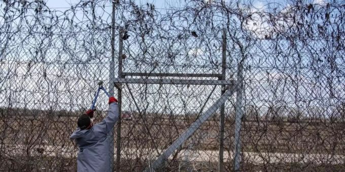 Ein Migrant versucht, an der türkisch-griechischen Grenze bei Pazarkule mit einer Drahtschere den Zaun durchzuschneiden. Foto: Yasin Akgul/dpa Ein Migrant versucht, an der türkisch-griechischen Grenze bei Pazarkule mit einer Drahtschere den Zaun durchzuschneiden. Foto: Yasin Akgul/dpa