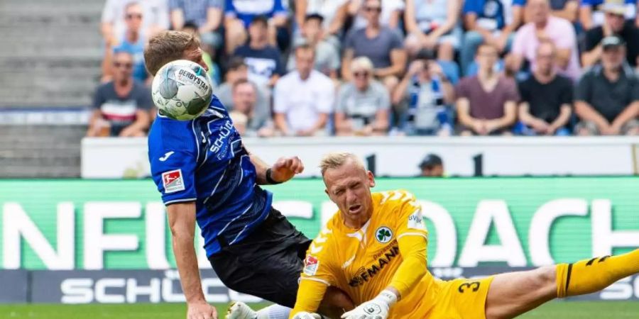 Fürth-Keeper Sascha Burchert versucht gegen Bielefelds Fabian Klos zu klären. Foto: Guido Kirchner
