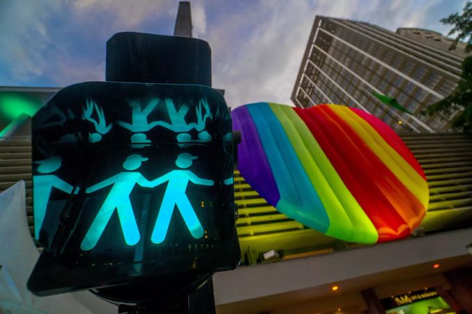 Eine Ampel mit zwei Männchen und eine Regenbogenflagge an der Paulista Avenue während der Gay-Pride-Parade. Hunderttausende Menschen sind bei der Gay-Pride-Parade durch die brasilianische Millionenmetropole São Paulo gezogen und haben gegen den rechtspopulistischen Präsidenten Bolsonaro protestiert. Gay-Pride-Parade in Sao Paulo