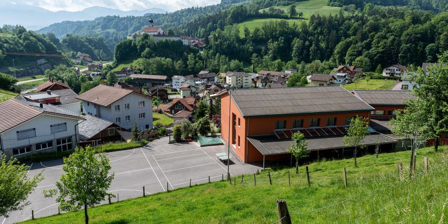 Schulareal und Schulhaus Werthenstein Unterdorf an der Halde 1 in Werthenstein. Im Hintergrund das Dorf, die Wallfahrtskirche und das Kloster Werthenstein.