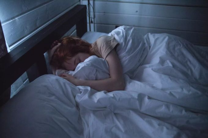 Bei kühleren Temperaturen sollte besser ein Pyjama getragen werden. Frau im Bett