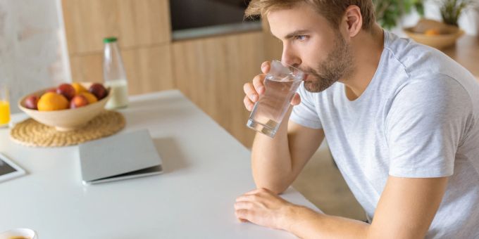 Keine Überraschung: Wasser ist gesund und sehr wichtig für unseren Körper. mann trinkt wasser