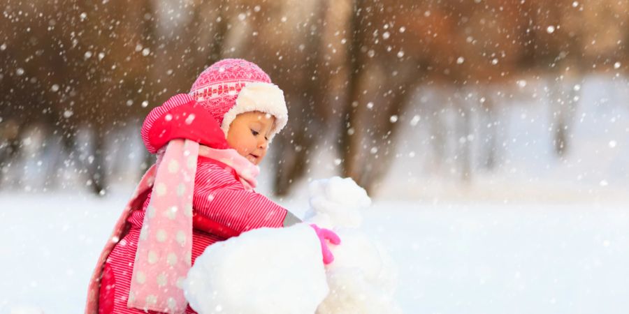 Kind spielt im Schnee