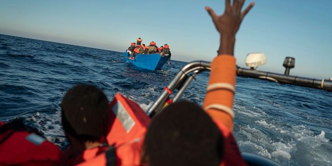 Migranten und Flüchtlinge treiben auf einem überfüllten Holzboot im Mittelmeer (Symbolbild). Migranten und Flüchtlinge treiben auf einem überfüllten Holzboot im Mittelmeer (Symbolbild).