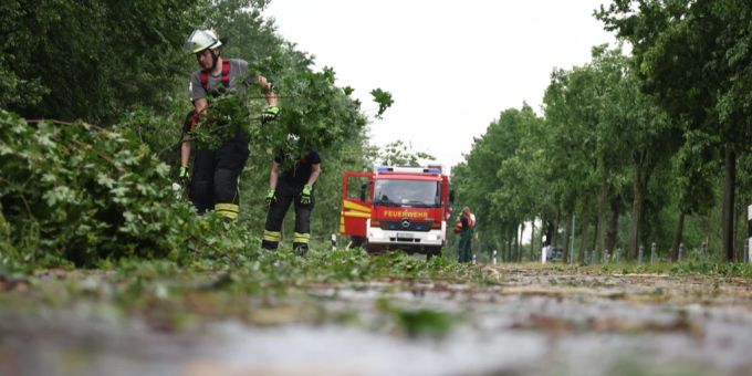 Nordrhein-Westfalen, Lippstadt: Feuerwehrleute entfernen Trümmer von einer Straße. Ein mutmaßlicher Tornado hat in Lippstadt am Freitagnachmittag massive Schäden verursacht. Foto: Friso Gentsch/dpa tornado