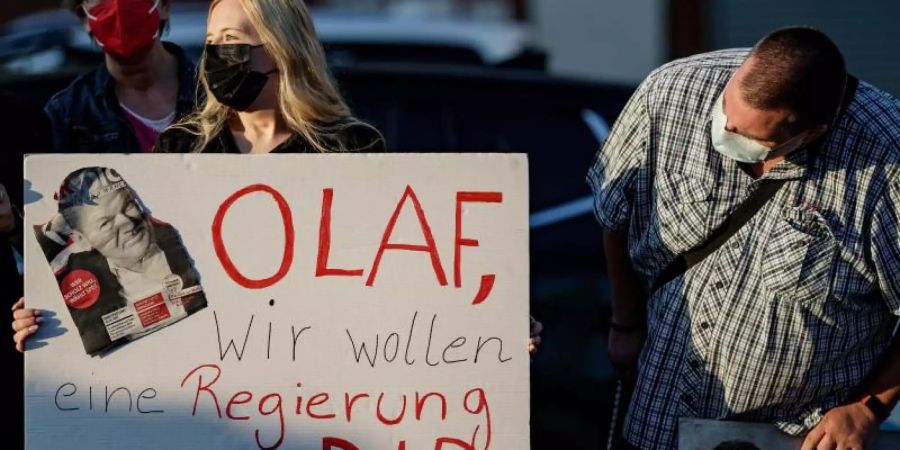 Anhänger von Olaf Scholz unterstützen den SPD-Kanzlerkandidaten bei einer Wahlkampfveranstaltung. Foto: Axel Heimken/dpa