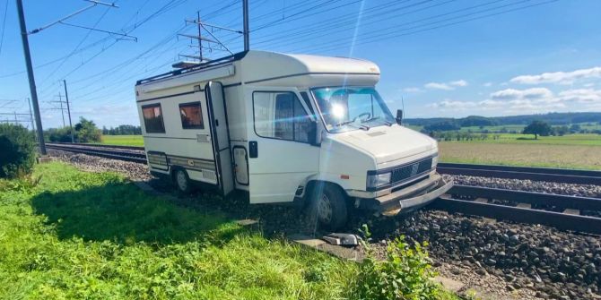 Wohnmobil zwischen Bahngleisen Grünstreifen