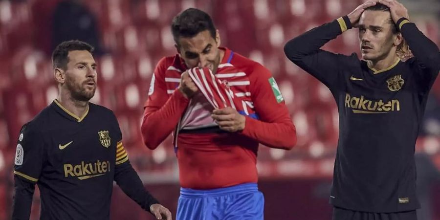 Antoine Griezmann (r) und Lionel Messi (l) sind mit dem FC Barcelona in Rückstand geraten. Foto: Uncredited/AP/dpa