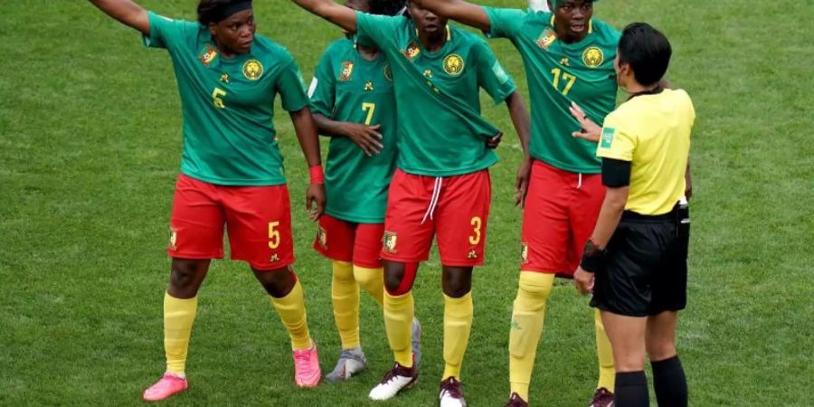 Die nigerianischen Spielerinnen beschweren sich bei Schiedsrichterin Liang Qin aus China (r) nach einer Entscheidung per Videobeweis. Foto: John Walton/PA Wire