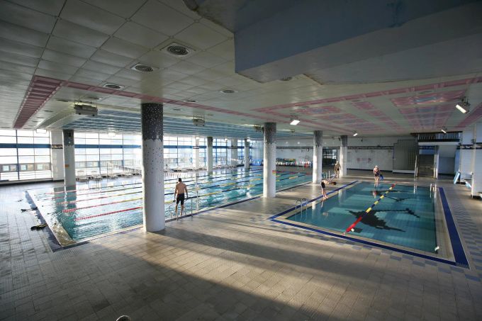 Schwimmen ist eine sanfte Sportart, denn es entlastet die Gelenke. Hallenbad Becken Schwimmer Sonne Licht